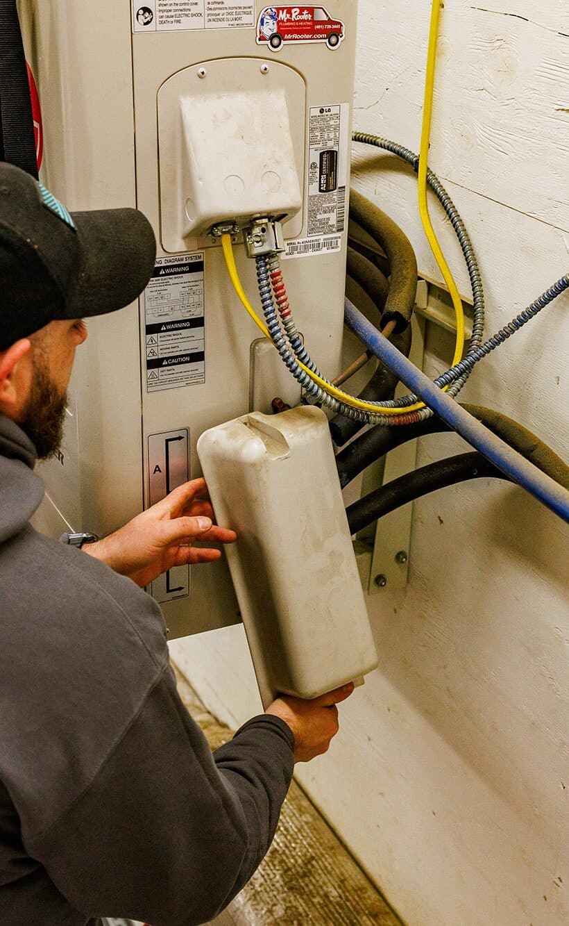 Prepare AC for summer | Technician working on AC unit | Greenwood Plumbing & Heating Air Conditioning & HVAC